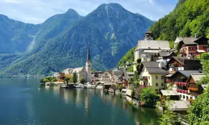 Malownicze domy nad jeziorem, w tle góry i kościół. To Hallstatt, gdzie znajduje się słynna kopalnia soli.