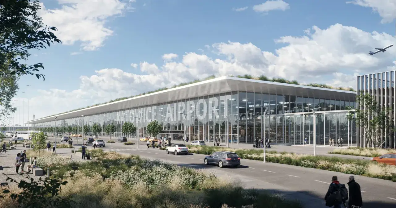 Nowoczesny budynek lotniska Katowice Airport z zielonym dachem, szklaną fasadą i napisem 